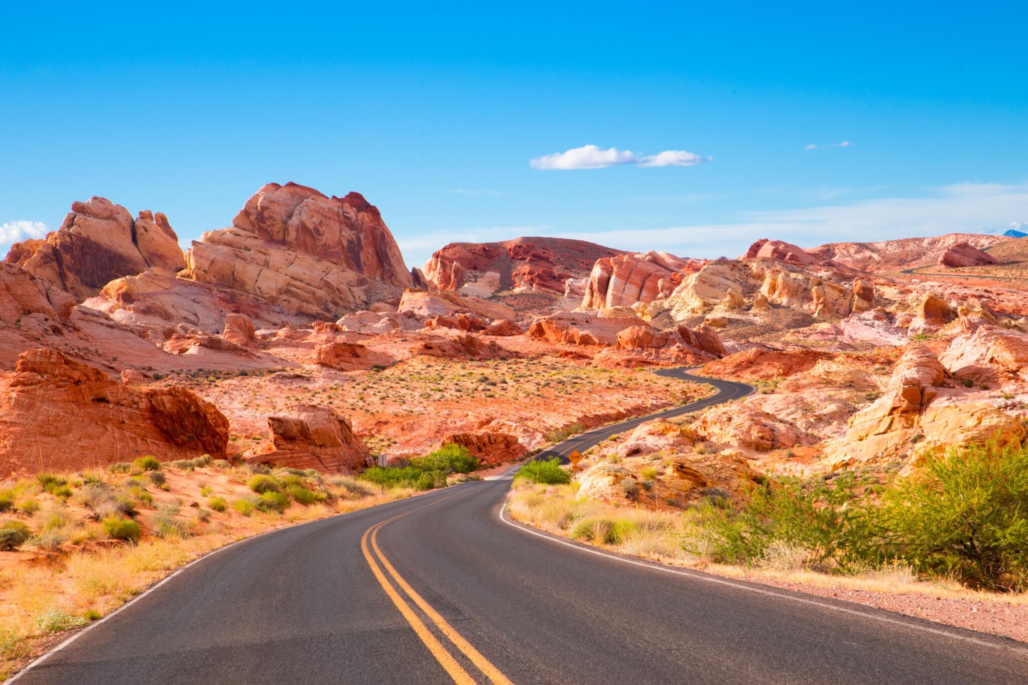 Cars drive down the highway in the American West