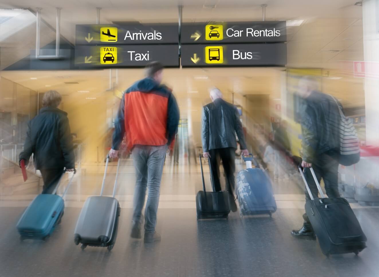 Airline Passengers in an Airport heading to car rentals and other transportation.