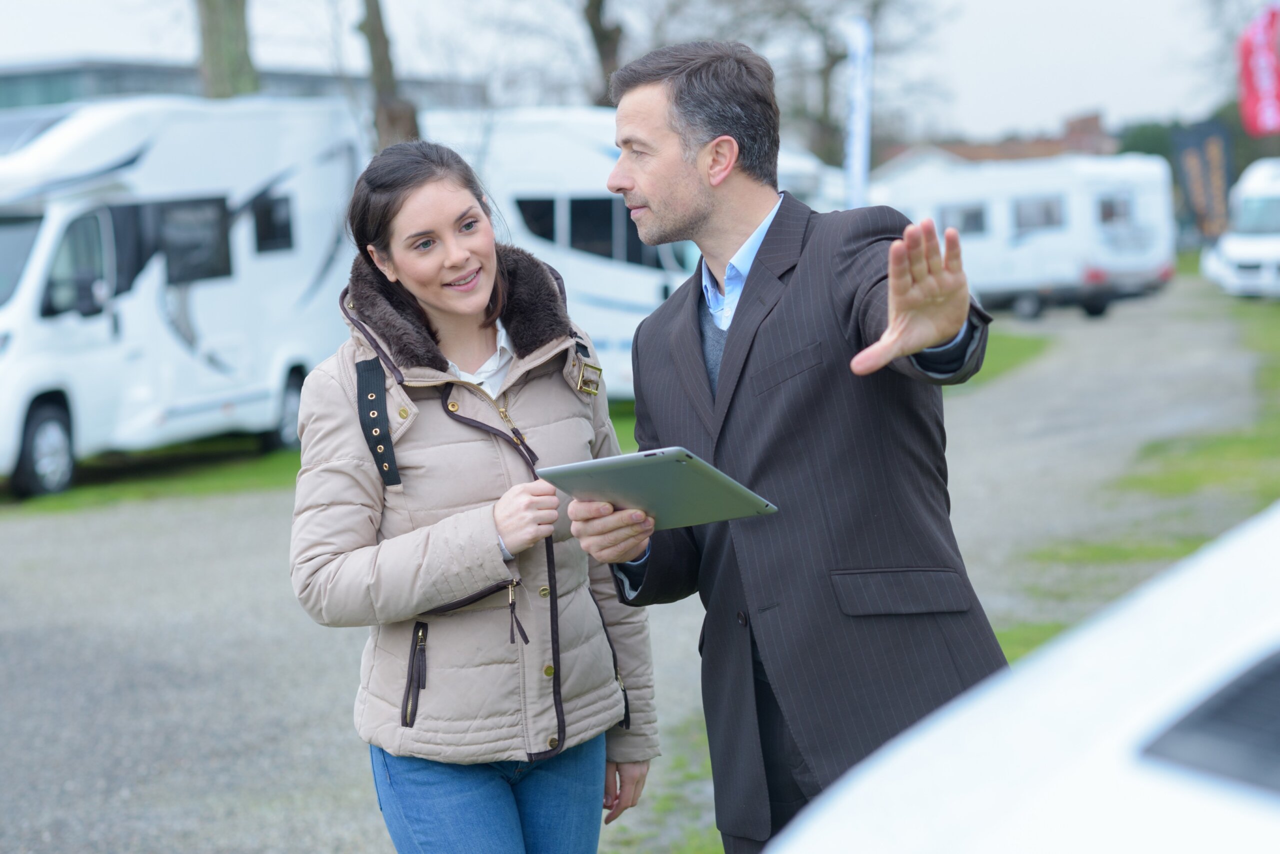 Woman asking the campervan salesman questions