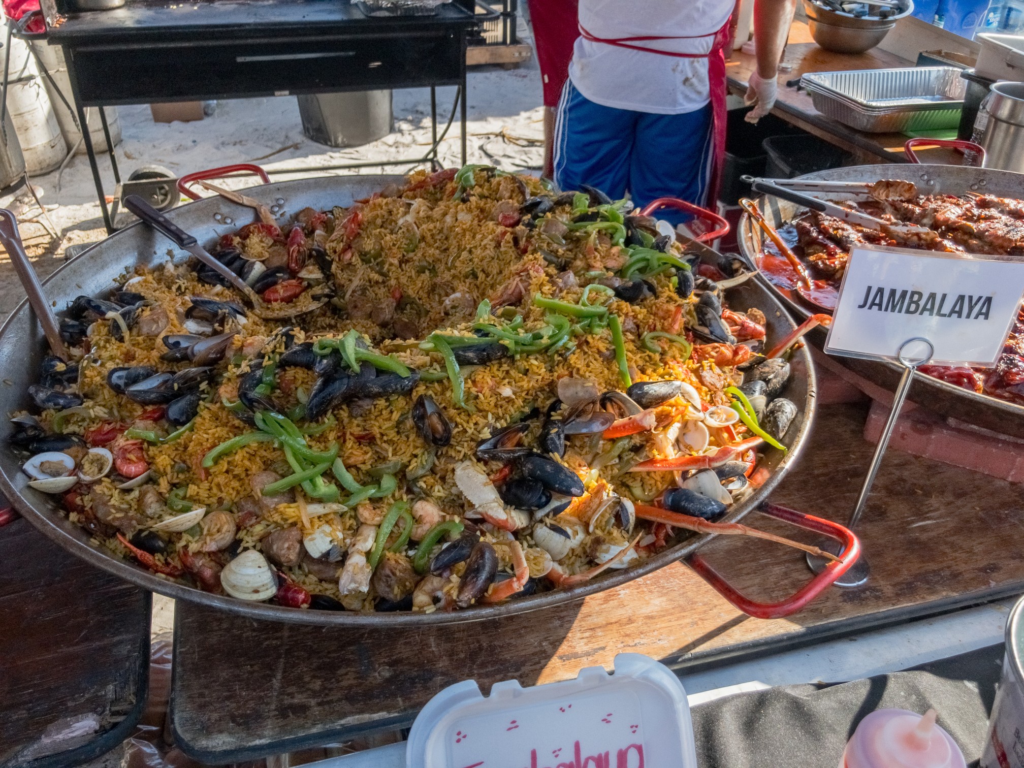 Close-up of a steaming pan of jambalaya, a traditional Louisiana dish made with rice, sausage, and spices.