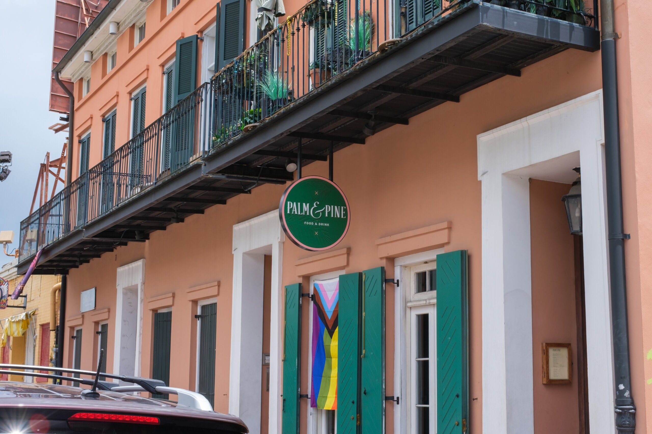 Exterior view of Palm & Pine restaurant on Rampart Street in the French Quarter of New Orleans, featuring its modern facade and welcoming signage.