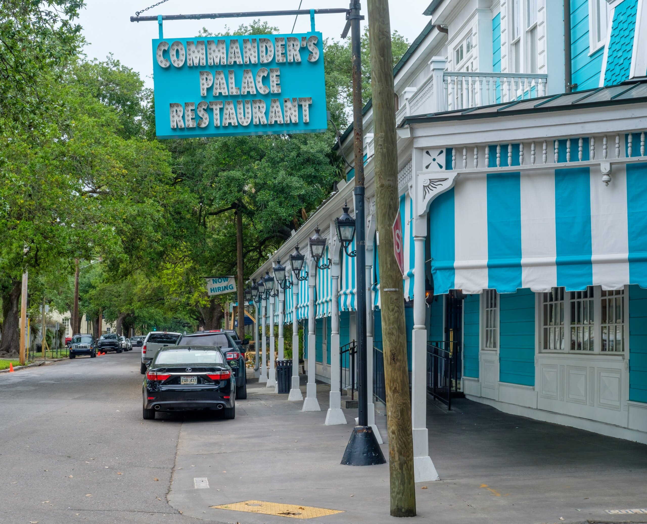Exterior of Commander’s Palace restaurant on Washington Avenue in the Garden District of New Orleans, known for its iconic turquoise facade and upscale Creole cuisine.