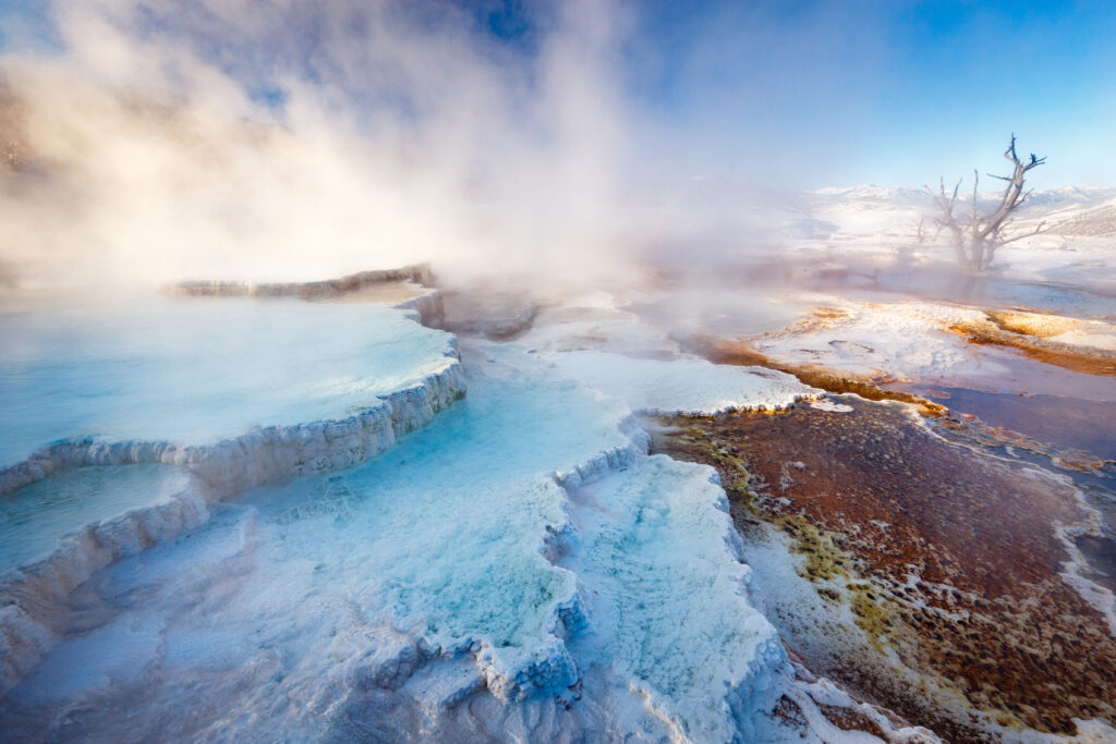 Mammoth Hot Springs with steamy terraces during winter snowy season 