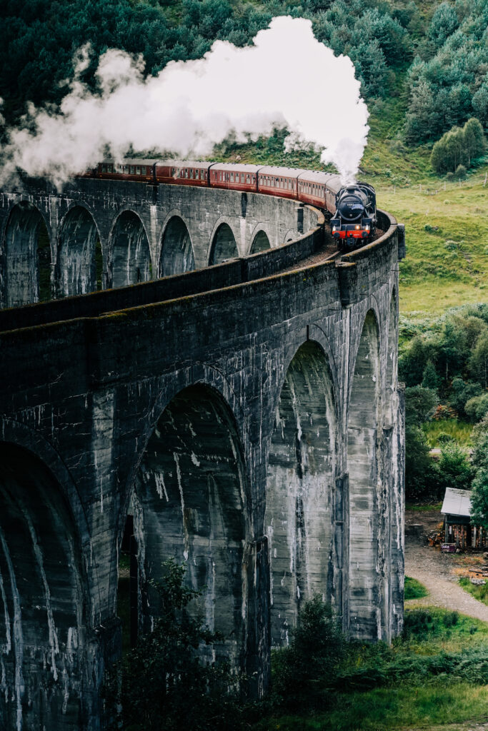 A steam train crossing the Glenfinnan viaduct in the Scottish Highlands made famous by the Harry Potter movies.