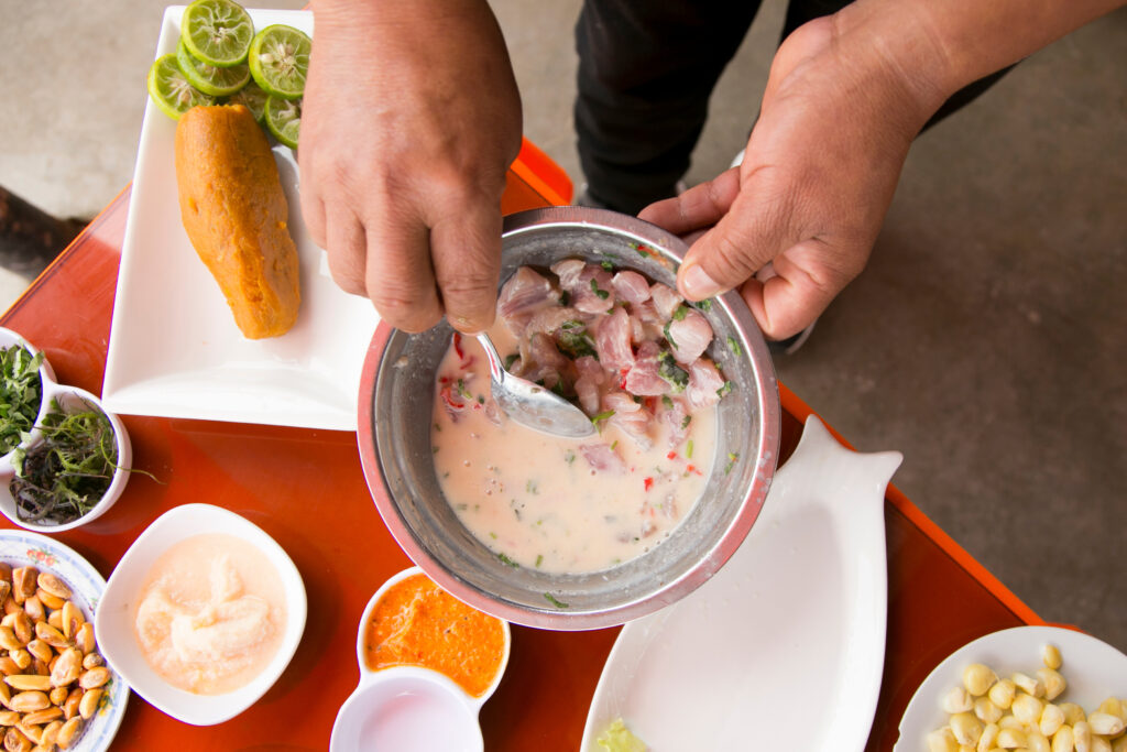 Preparing a delicious Peruvian sea bass ceviche in the fishing port of Chorríos in Lima.