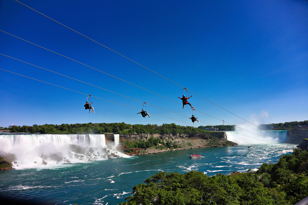 Tourists flying on zipline over Niagara Falls