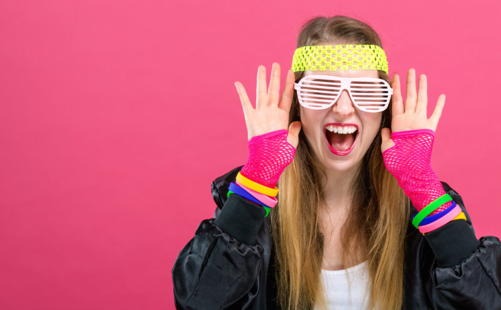 Woman in 1980's fashion theme on a pink background