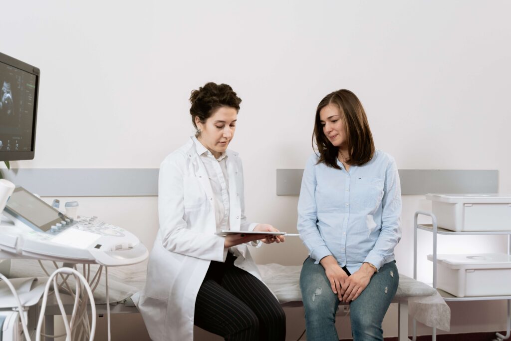 Woman sitting next to her doctor