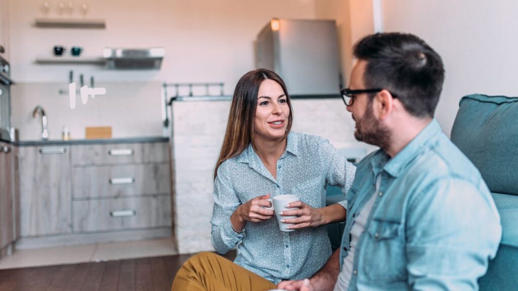 A couple talking while sitting on a couch