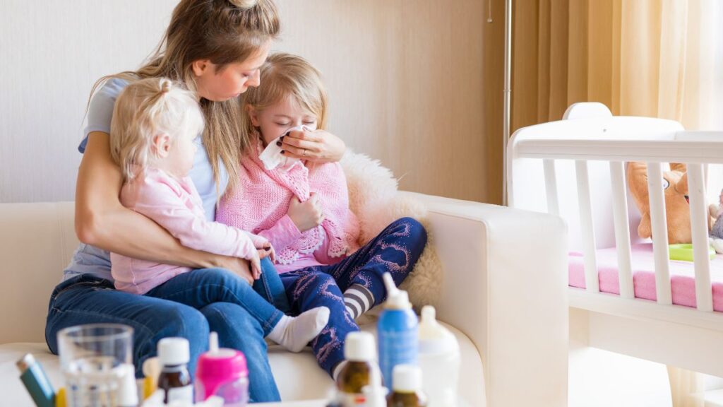 Mother holding two children on her lap