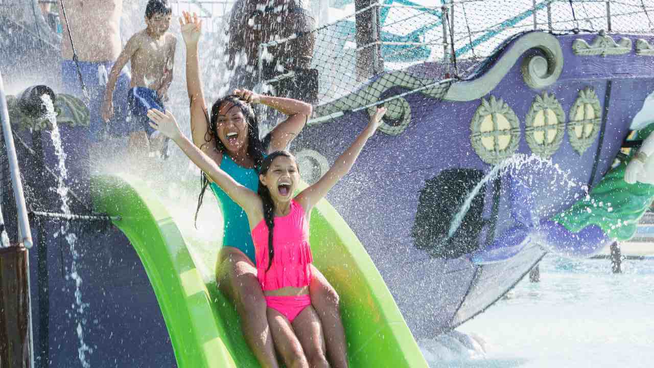 a family having fun on a water slide at a water park