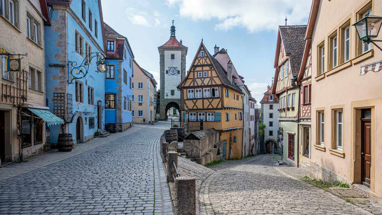 a cobblestone street lined with colorful buildings in germany