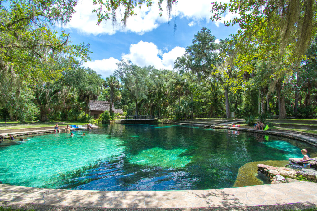 A family enjoying a cool dip in a natural fresh water springs swimming hole at Juniper Springs in Ocala national forest in central Florida, north of Orlando.