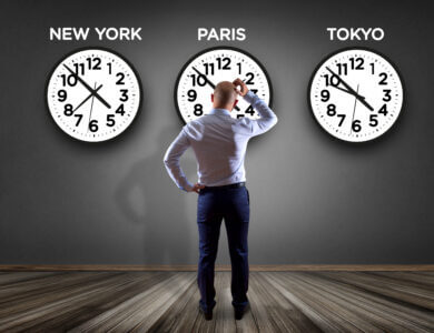 Businessman in front of a wallwith clocks of different country - Jetlag concept