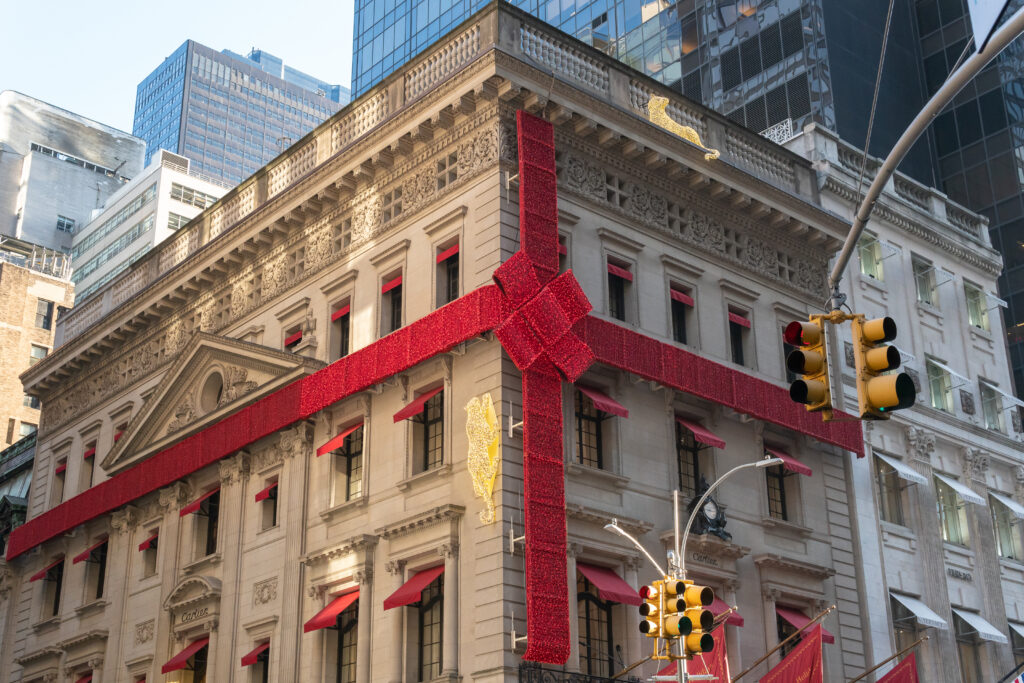 New York City, New York - December 2019: 2019 installation of the Cartier flagship store on Fifth Avenue with the gigantic bow and jaguars climbing the sides.