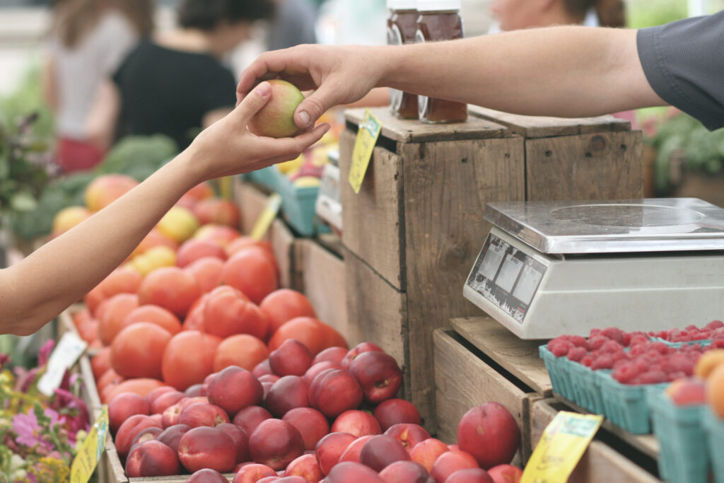 Person giving fruit to another