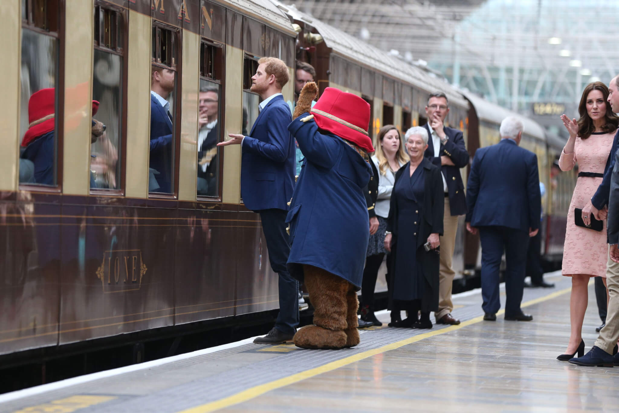 Prince Harry stands with a costumed figure of Paddington bear as he speaks to children onboard the Belmond British Pullman train on platform 1 at Paddington Station, London, as he attends the Charities Forum event, joining children from the charities he supports and to meet the cast and crew from the forthcoming film 'Paddington 2'