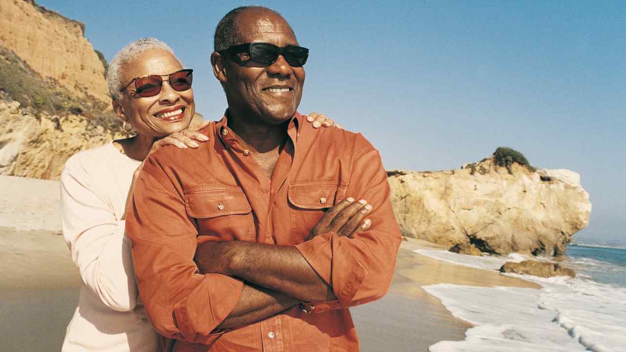 Two people standing on the beach