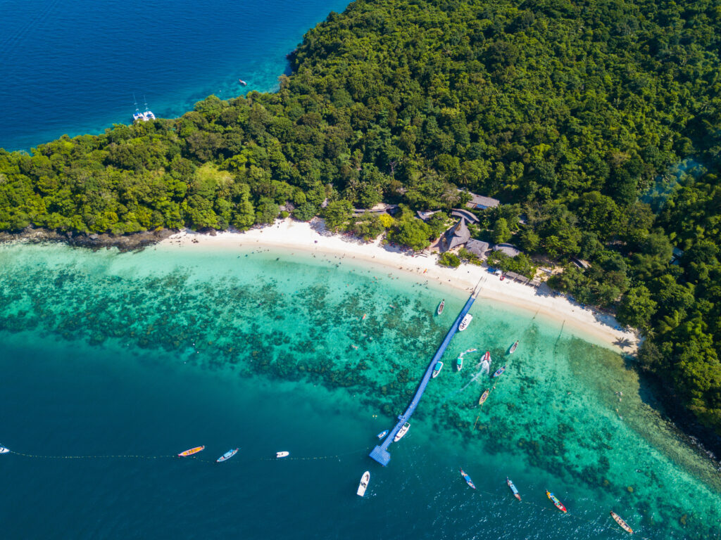 Aerial view or top view of tropical island beach with clear water at Banana beach, Coral Island, Koh Hey, Phuket