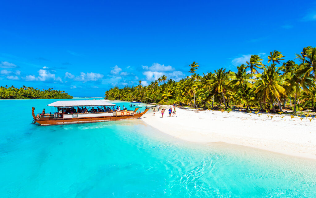 Boat on a sandy beach in Aitutaki island, Cook Islands, South Pacific. Copy space for text.