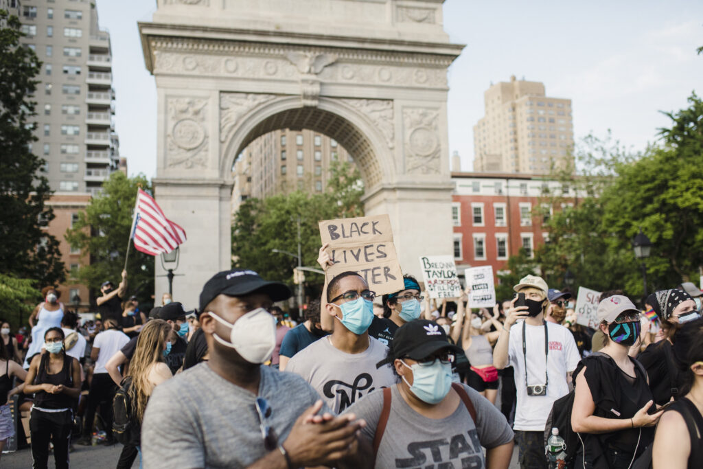 Crowd of protesters holding signs