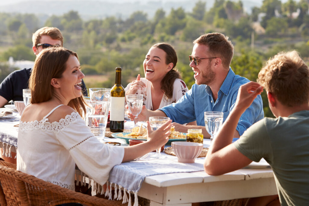 Group Of Young Friends Enjoying Outdoor Meal On Holiday