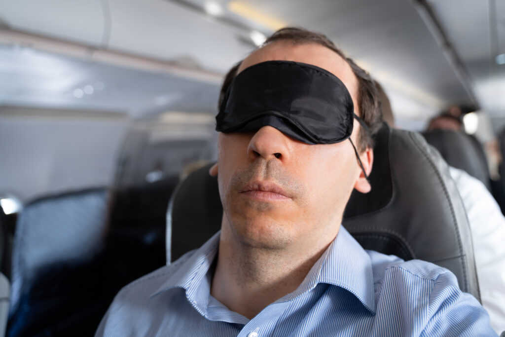 Man With Sleep Mask On Airplane
