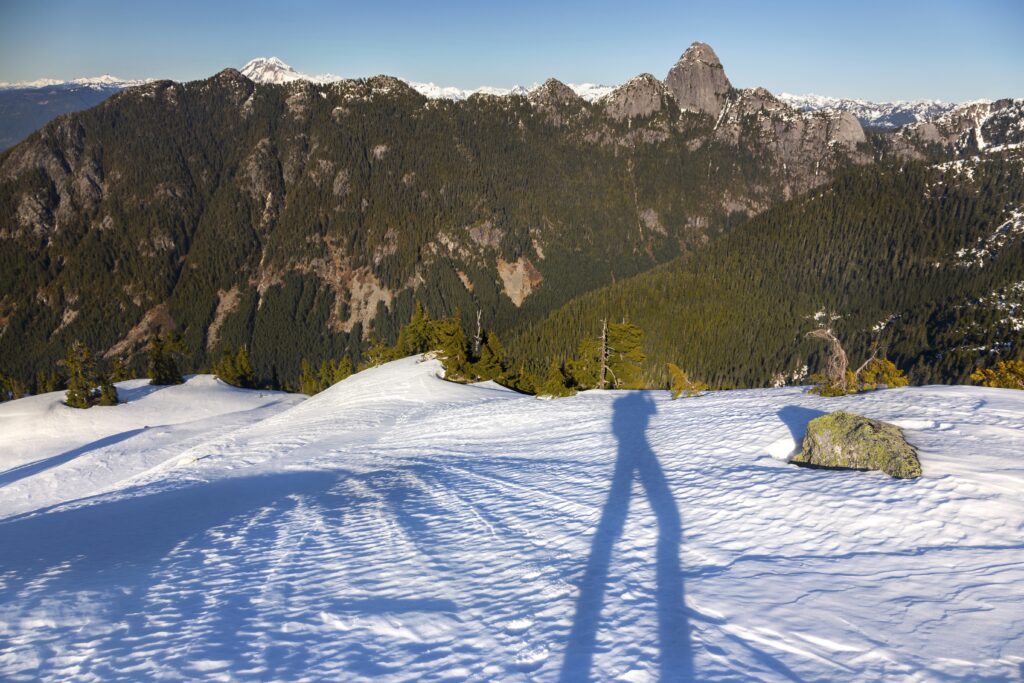 Photographer Shadow reflected while snowshoeing Skyline Ridge above Sea to Sky Gondola near Squamish, British Columbia