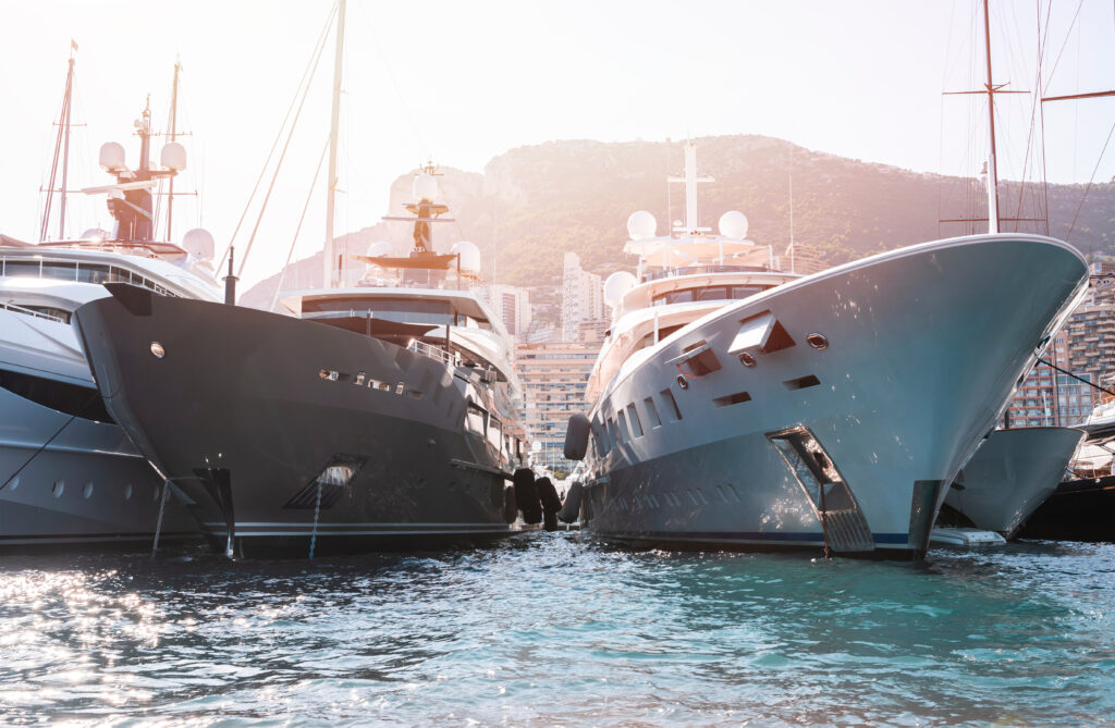 Private super yachts moored in Monaco harbour sunny day Monaco yacht show luxury lifestyle