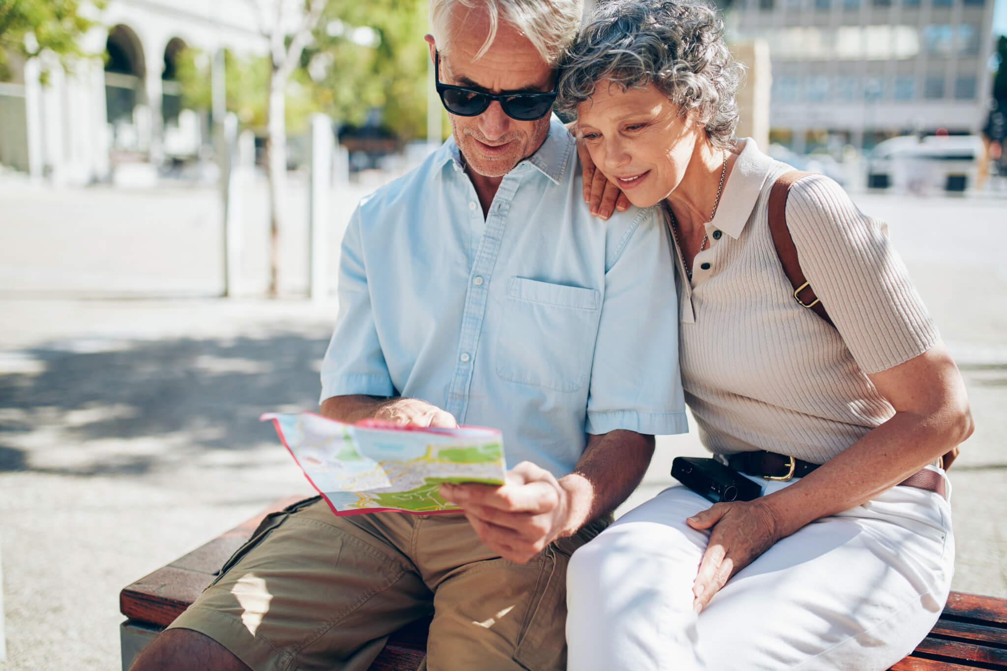 Senior couple looking for a destination on a city map
