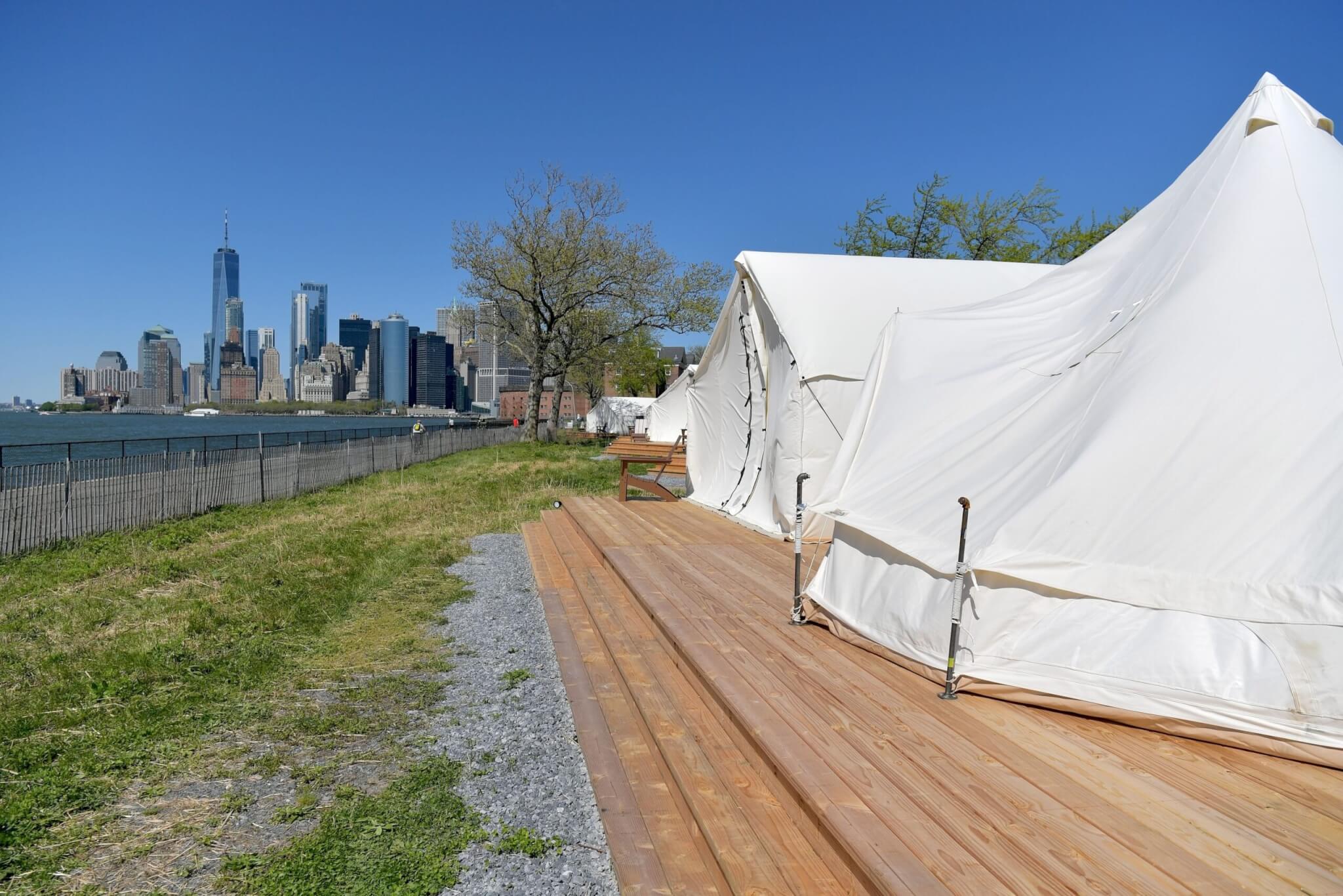 Collective Retreats "glamping" as seen during the Governor's Island Reopening with Lower Manhattan visible in the background.