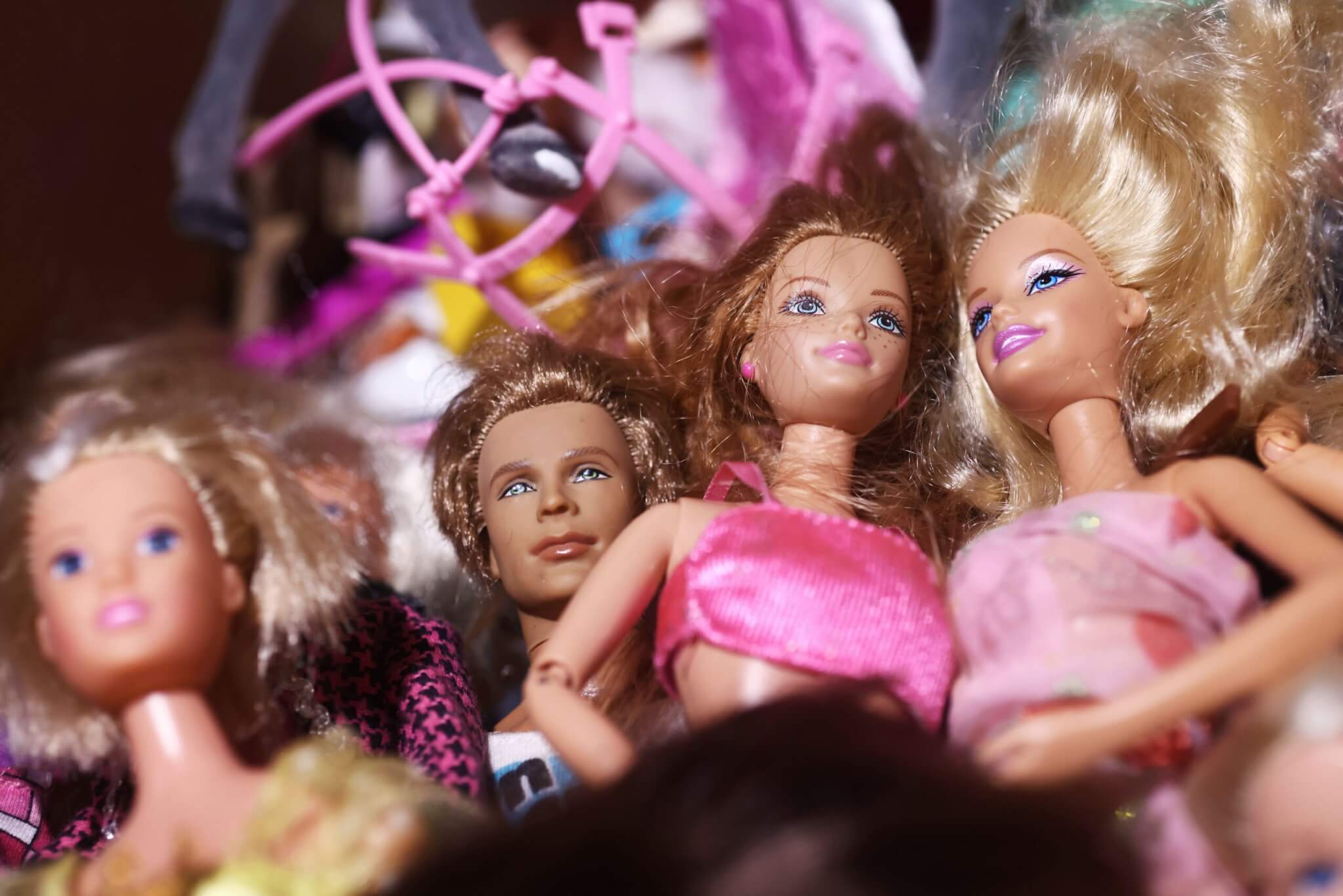 A box of toys in a box in an attic of a house, here Barbie dolls.