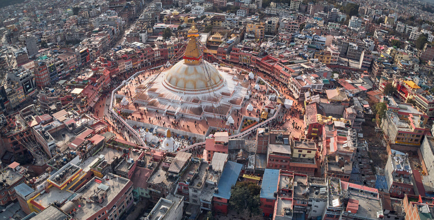 Panoramic Aerial view on streets of Kathmandu and a stupa of Boudhanath is created in the form of a Buddhist mandala. Nepal, shooting from the drone.