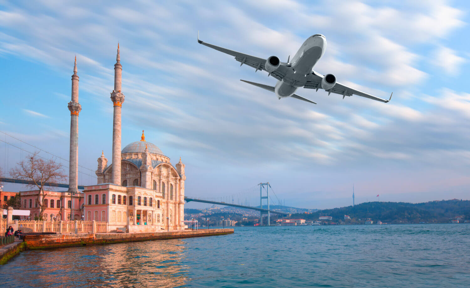 Airplane flying over Ortakoy Mosque  - Istanbul, Turkey