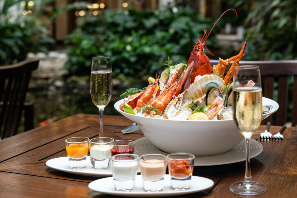 Seafood platter and champagne representing fine dining destinations in the U.S. for food lovers seeking luxury cuisine