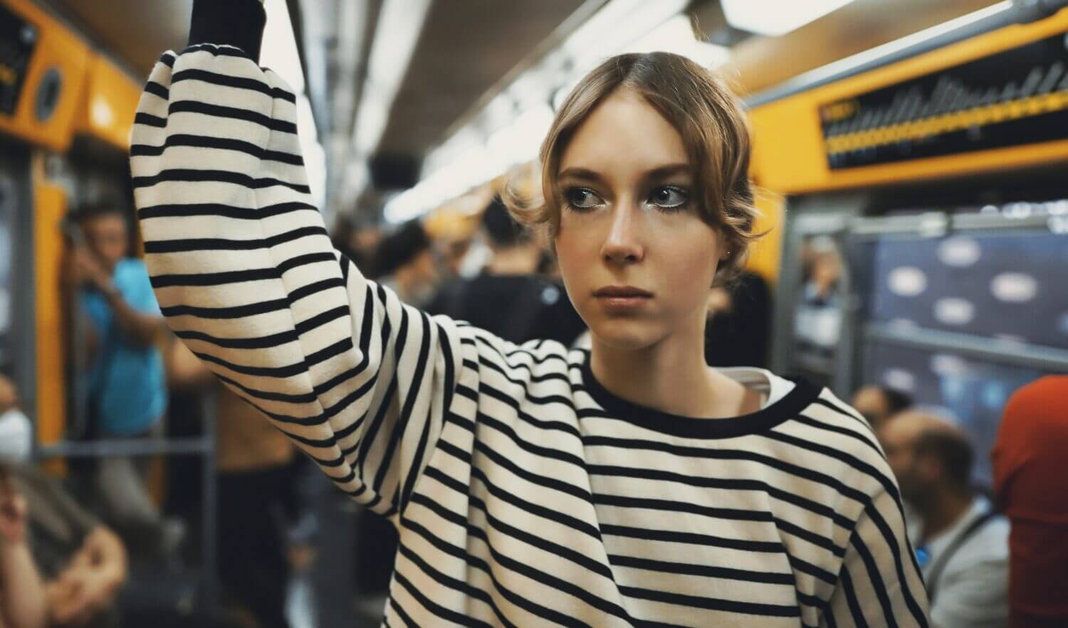 Teenage girl rides in a subway train.