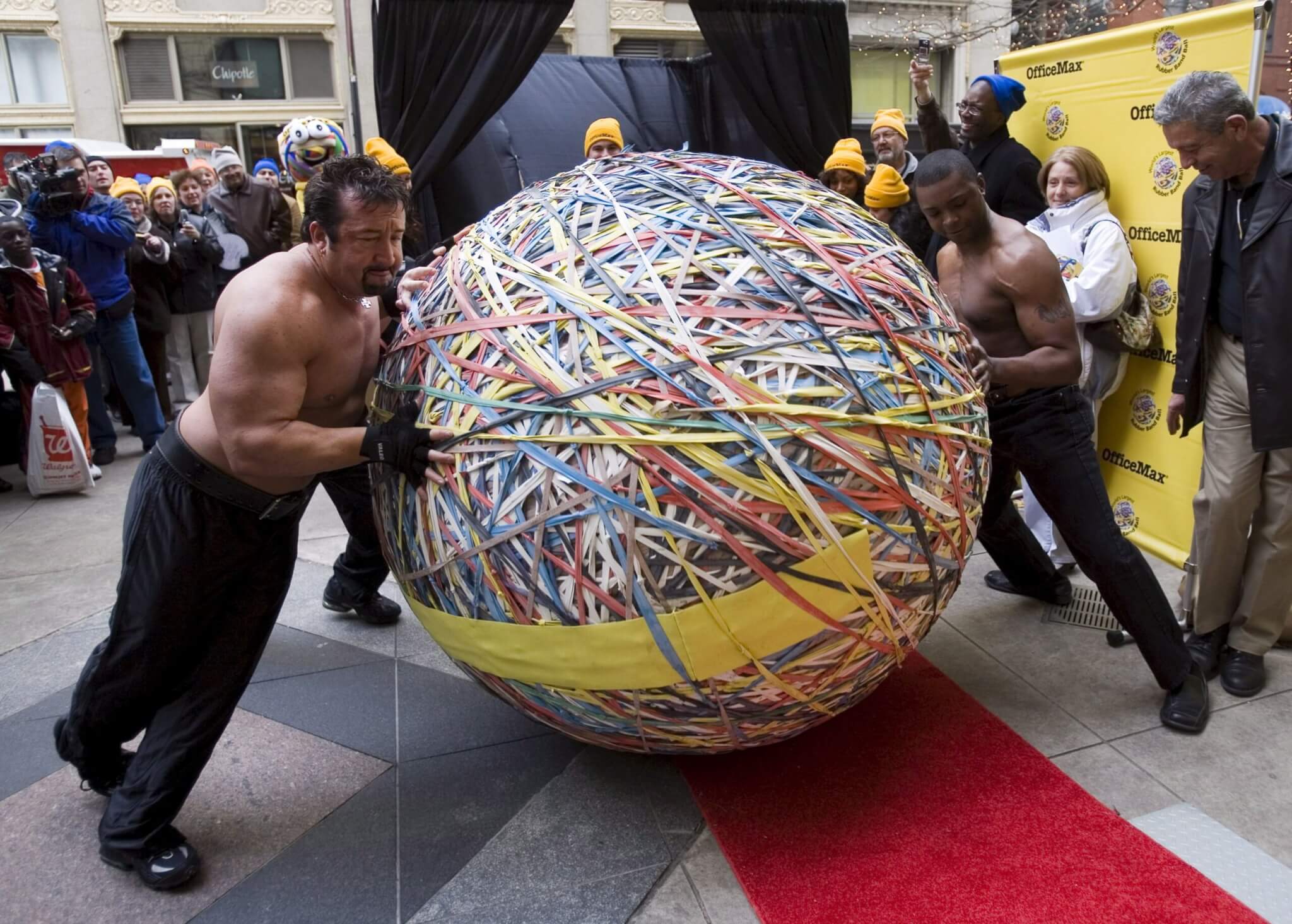 Musclemen Move What is Being Claimed As the 'World's Largest Rubber Band Ball' to the Scales at Its Official Guinness World Record Weigh-in in Downtown Chicago Illinois Tuesday 21 November 2006 the Ball Contains 175 000 Individual Rubber Bands Stands Five Feet Six Inches Tall and Has a Circumference of 19 Feet Creator Steve Milton Started the 4594 Pound Ball in His Eugene Oregon Home in November 2005 the Previous Record For a Rubber Band Ball is 3 120 Pounds