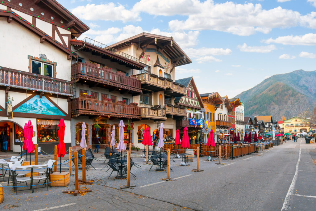 The main street through the Bavarian themed village of Leavenworth with outdoor sidewalk cafes lining up in the late Autumn in Eastern Washington State, USA.