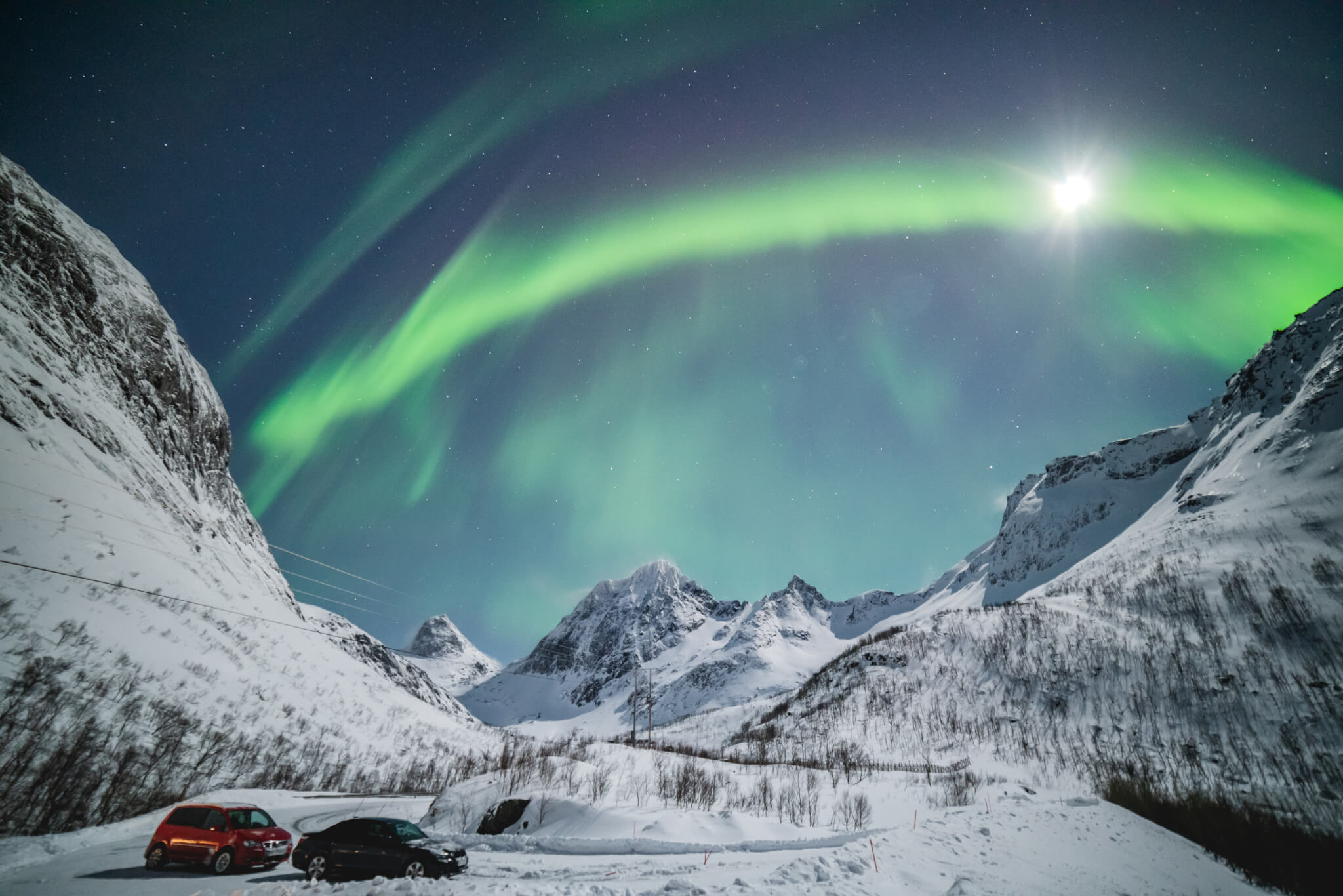 Aurora borealis and sun visible in sky of northern norway