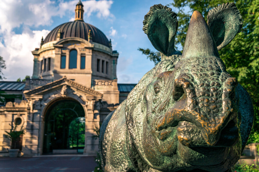 Bronx zoo center entrance.  It is the largest metropolitan zoo in the United States and among the largest in the world. Rhinoceros statue.