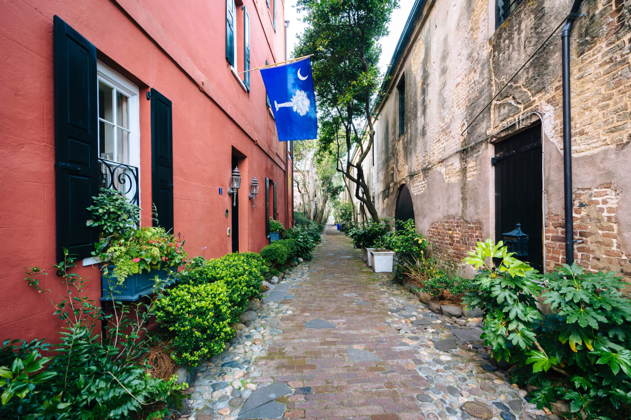 Narrow cobblestone street and old buildings in Charleston, South