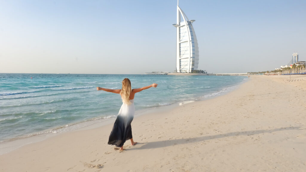 Photography of woman walking on seashore