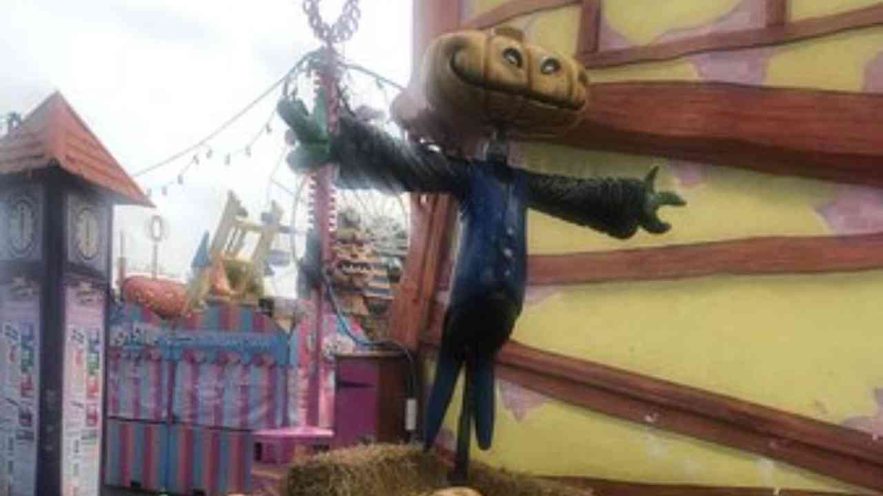 a scarecrow is sitting on top of a pile of hay