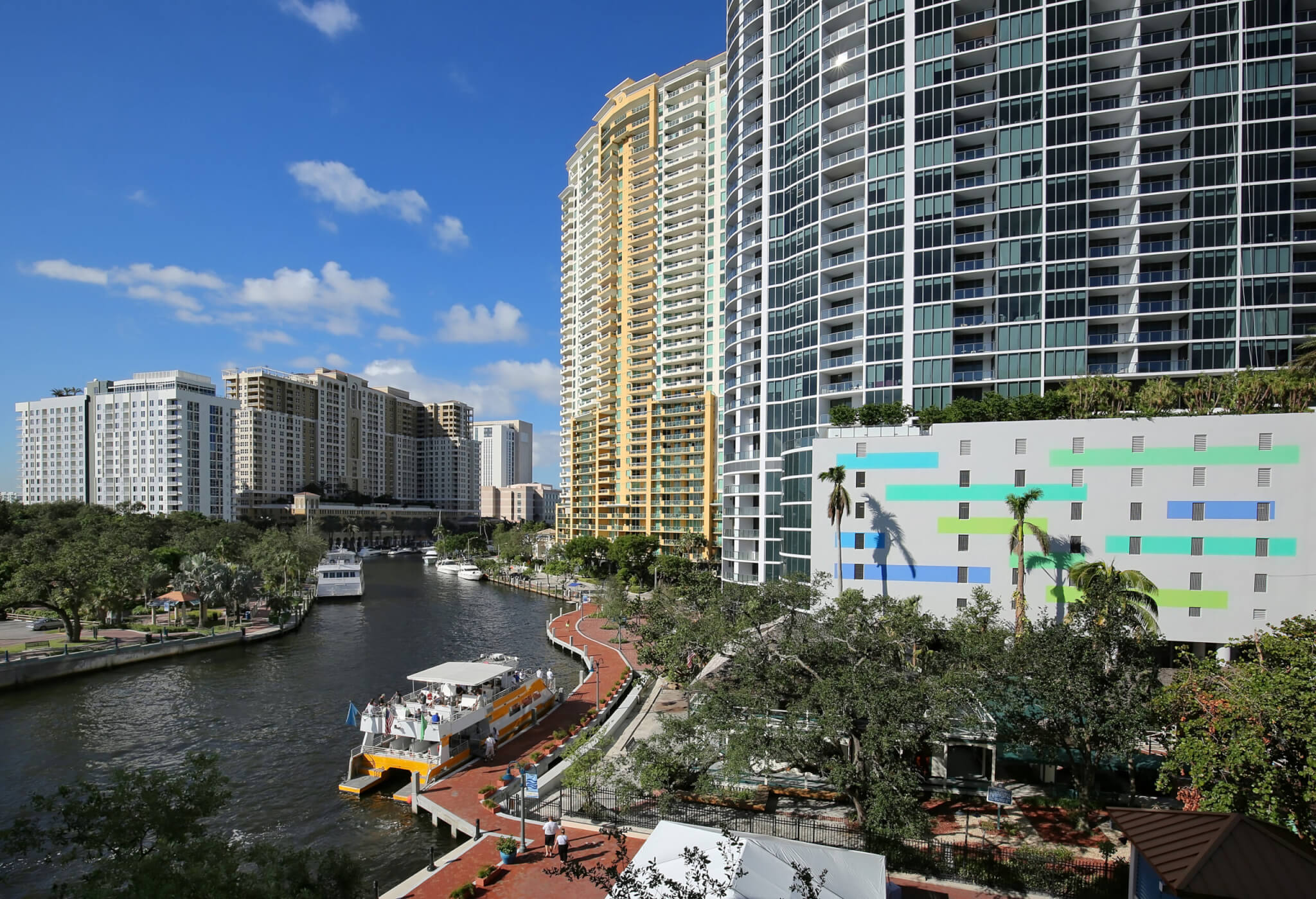 Aerial view of Fort Lauderdale's Riverfront, bustling with boating activity and lined with high rise condos and apartments located in the heart of downtown Fort Lauderdale.