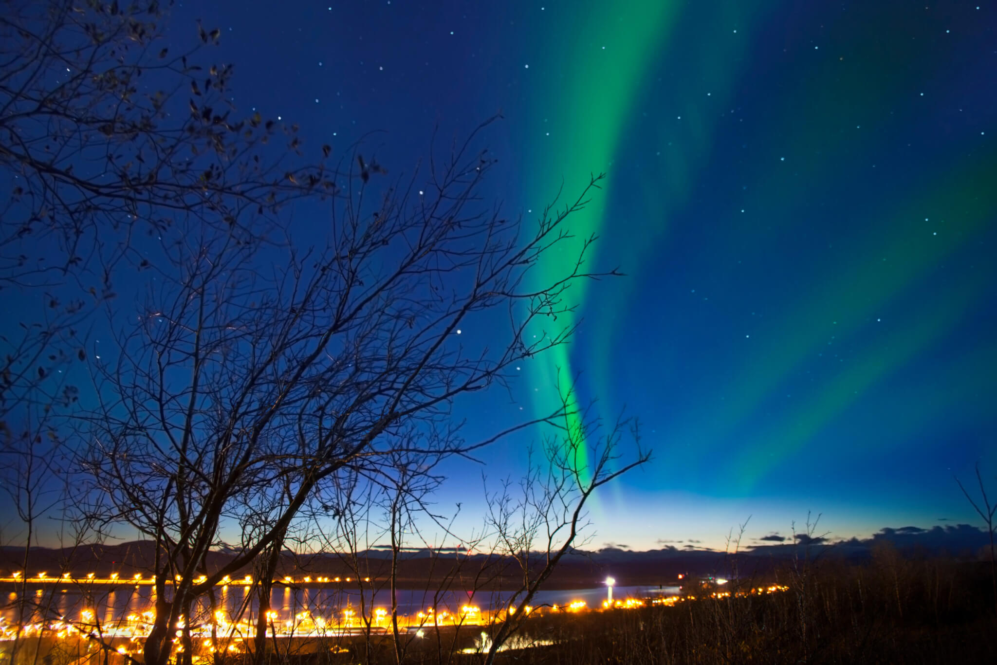 Aurora with the light on the horizon at Kiruna Cityscape, Sweden