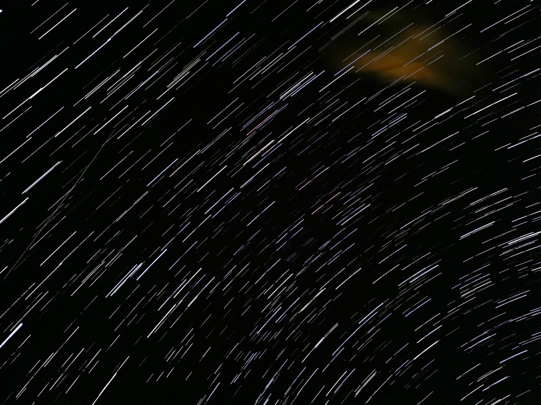 Motion shot of the blurred stars above Uluru mountain, Australia