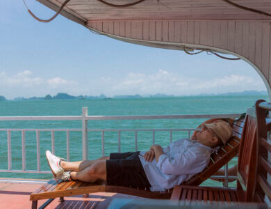 Photo of a man sleeping in a lounger on a boat