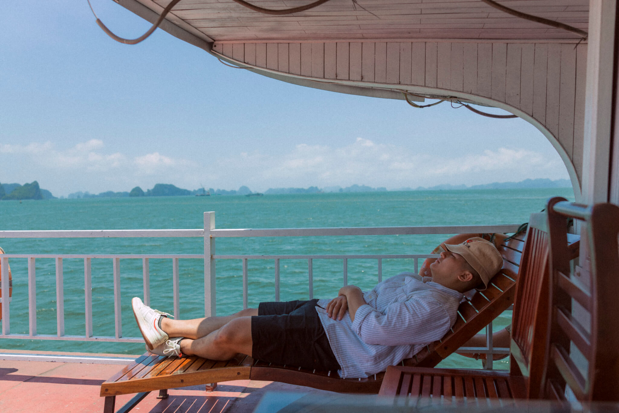 Photo of a man sleeping in a lounger on a boat
