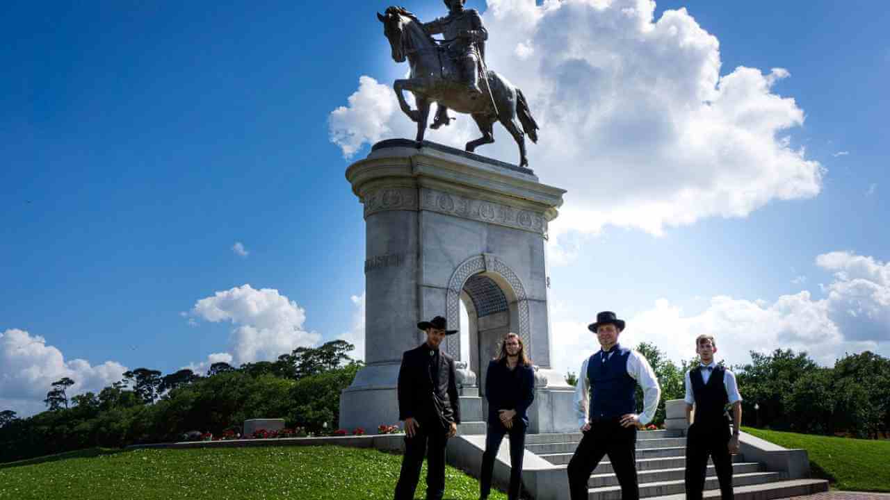 a group of people standing in front of a statue