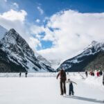 people wearing ice skates with mountain at the distance